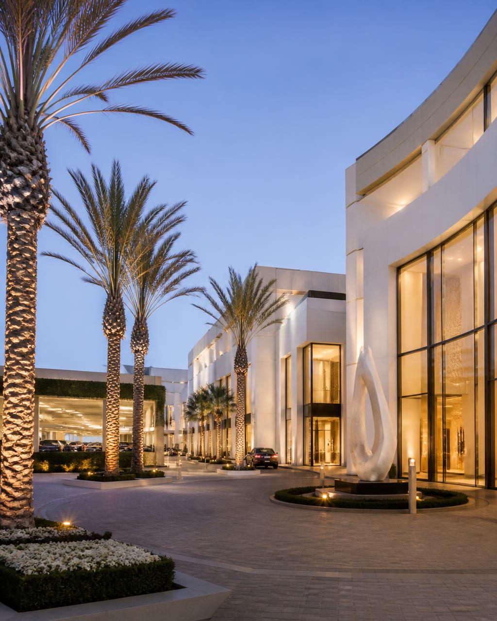 Upscale open-air luxury shopping center plaza at dusk